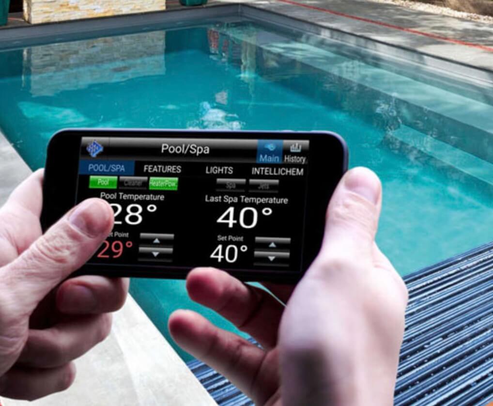 Homeowner using the best pool automation system to monitor their pool.