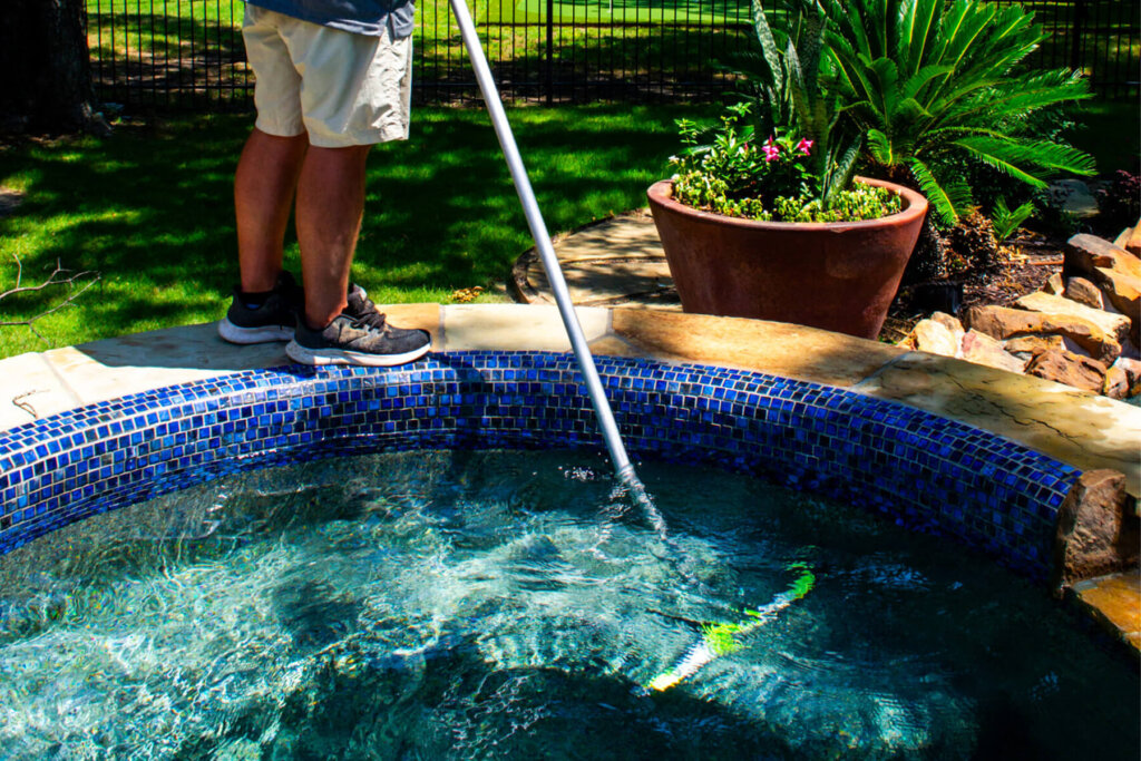 Dedicated employee conducting regular pool inspections and maintenance.