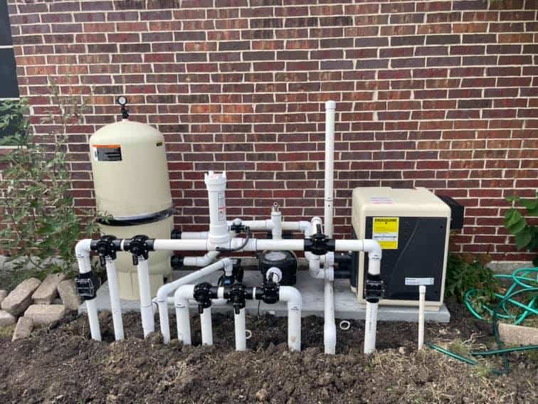 Pool pump and pipes shown after pool repairs completed.