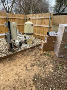 Pool pump surrounded by delivery boxes full of parts to make repairs.