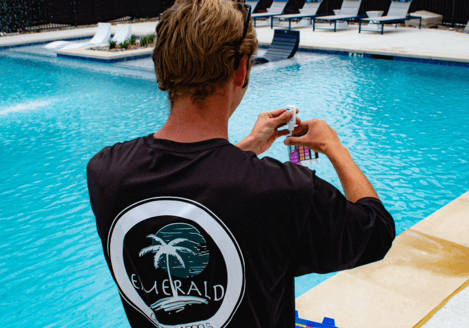 Emerald employee checking pool chemical levels to help extend the life of your pool.