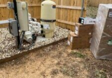 Pool pump surrounded by delivery boxes full of parts to make repairs.