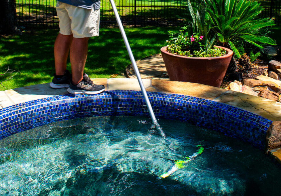 Dedicated employee conducting regular pool inspections and maintenance.